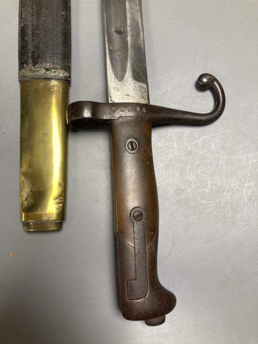 An Italian Torre Annunziata bayonet, 51cm blade, within leather and brass scabbard